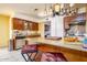 Bright kitchen featuring a center island with seating, stainless steel appliances, and wooden cabinetry at 15212 N 37Th Ave, Phoenix, AZ 85053