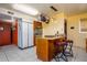 Charming kitchen boasts tile flooring, center island, and pot rack, perfect for cooking enthusiasts at 15212 N 37Th Ave, Phoenix, AZ 85053