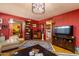 Open living room with comfortable leather seating, tv, and views of the dining room at 15212 N 37Th Ave, Phoenix, AZ 85053