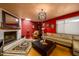 Comfortable living area with fireplace, elegant light fixture, and lots of natural light at 15212 N 37Th Ave, Phoenix, AZ 85053