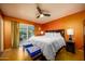 Inviting primary bedroom with ample space, ceiling fan, and access to a private outdoor patio at 15212 N 37Th Ave, Phoenix, AZ 85053