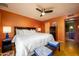 Spacious primary bedroom features a ceiling fan, laminate flooring, and a king-sized bed at 15212 N 37Th Ave, Phoenix, AZ 85053