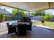 Charming covered patio with dining area and fireplace, perfect for outdoor entertaining and relaxation at 15212 N 37Th Ave, Phoenix, AZ 85053