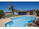 Private pool area with solar panels on the house, surrounded by fencing and seating area at 15212 N 37Th Ave, Phoenix, AZ 85053