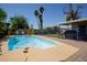 Backyard pool surrounded by lush landscaping, patio area, and privacy fencing for serene outdoor enjoyment at 15212 N 37Th Ave, Phoenix, AZ 85053