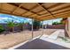 Covered patio overlooking the spacious backyard with desert landscaping at 1643 W Naranja Ave, Mesa, AZ 85202