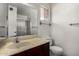 The bathroom features tile floors, a vanity sink, and a shower with a glass door at 1643 W Naranja Ave, Mesa, AZ 85202