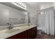 This clean bathroom has a dual sink vanity and a shower-tub combo at 1643 W Naranja Ave, Mesa, AZ 85202
