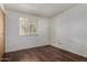 This bedroom features wood laminate flooring, closet and natural light at 1643 W Naranja Ave, Mesa, AZ 85202