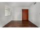 Clean bedroom with wood floors, closet, and window offering natural light at 1643 W Naranja Ave, Mesa, AZ 85202