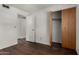 Bedroom featuring wood laminate flooring, closets and neutral paint at 1643 W Naranja Ave, Mesa, AZ 85202