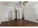Bedroom featuring wood laminate flooring, closet and ceiling fan at 1643 W Naranja Ave, Mesa, AZ 85202