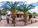 Inviting single-story brick home with desert landscaping and mature palm trees at 1643 W Naranja Ave, Mesa, AZ 85202