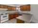 Traditional style kitchen with white appliances, ample wood cabinets, and neutral countertops at 1643 W Naranja Ave, Mesa, AZ 85202