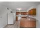 Bright eat-in kitchen features tile flooring, wood cabinets, and matching white appliances at 1643 W Naranja Ave, Mesa, AZ 85202