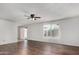 Bright living room with wood floors, ceiling fan, and sliding door to the backyard at 1643 W Naranja Ave, Mesa, AZ 85202