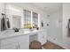 Bright bathroom featuring double sinks, quartz countertops, and a walk-in shower with white subway tile at 16875 N 12Th St # 31, Phoenix, AZ 85022