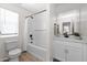 Bathroom featuring a tub and shower combo, a single sink vanity with a large mirror, and a toilet at 16875 N 12Th St # 31, Phoenix, AZ 85022