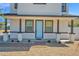 Charming front porch with a blue front door, brick accents, and manicured landscaping at 16875 N 12Th St # 31, Phoenix, AZ 85022