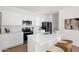 Modern kitchen features white cabinets, stainless steel appliances, and a spacious island with bar seating at 16875 N 12Th St # 31, Phoenix, AZ 85022