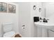 Well-lit half bathroom with modern fixtures, decorative art, and wood-look flooring at 16875 N 12Th St # 33, Phoenix, AZ 85020