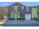 Charming two-story home showcasing modern architecture and a well-manicured front yard with a vibrant green door at 16875 N 12Th St # 33, Phoenix, AZ 85020