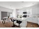 Modern, all-white kitchen with stainless steel appliances, a center island, and an adjacent dining area at 16875 N 12Th St # 33, Phoenix, AZ 85020
