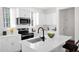 Bright kitchen featuring white cabinetry, modern stainless steel appliances, and a center island with seating at 16875 N 12Th St # 33, Phoenix, AZ 85020