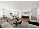 Open-concept living area with wood floors, a modern kitchen, comfortable seating, and plenty of natural light at 16875 N 12Th St # 33, Phoenix, AZ 85020