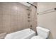 Cozy bathroom featuring a shower over bath with tile surround and shower caddy at 1733 N Miller Rd, Scottsdale, AZ 85257