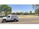 Neighborhood street view showing the property, parking, and attractive desert landscaping at 1733 N Miller Rd, Scottsdale, AZ 85257
