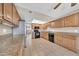 Traditional-style kitchen with granite countertops, tile flooring, and stainless steel refrigerator at 1733 N Miller Rd, Scottsdale, AZ 85257
