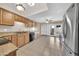 Functional kitchen features wooden cabinets, black appliances, tile floors, and backyard access at 1733 N Miller Rd, Scottsdale, AZ 85257