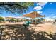 A playful oasis: shaded playground with spring riders and many structures for children to enjoy at 1733 N Miller Rd, Scottsdale, AZ 85257