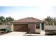 Charming single-story home with a two-car garage, brick accent, and low maintenance desert landscaping at 18174 W Larkspur Dr, Goodyear, AZ 85338