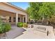 Inviting back patio features a charming fireplace, covered area, and lush landscaping for relaxed outdoor living at 1896 E Stephens Dr, Tempe, AZ 85283