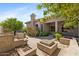 Backyard featuring built-in barbecue, waterfall, desert landscaping, and covered patio at 1896 E Stephens Dr, Tempe, AZ 85283