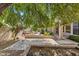 Backyard showcasing the built-in barbecue, waterfall feature, and mature landscaping at 1896 E Stephens Dr, Tempe, AZ 85283