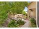 Backyard showcasing the built-in barbecue, waterfall feature, and mature landscaping at 1896 E Stephens Dr, Tempe, AZ 85283