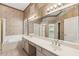 Classic bathroom with dual sinks, soaking tub, and a glass block window at 1896 E Stephens Dr, Tempe, AZ 85283