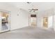 Bright bedroom features a ceiling fan, carpeted flooring and access to the bathroom at 1896 E Stephens Dr, Tempe, AZ 85283