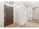 Spacious foyer with tile flooring, a modern front door, and arched doorways offering inviting natural light at 1896 E Stephens Dr, Tempe, AZ 85283