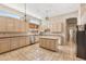 Bright kitchen featuring an island, tile floors, plentiful cabinets, and a window over the sink at 1896 E Stephens Dr, Tempe, AZ 85283