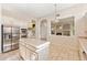 Traditional kitchen boasts stainless steel appliances, a center island, and views into the living room fireplace at 1896 E Stephens Dr, Tempe, AZ 85283