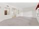 Bright living room with neutral carpet, archways, and large windows allowing lots of natural light at 1896 E Stephens Dr, Tempe, AZ 85283