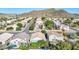 Expansive aerial view of a residential neighborhood nestled near a scenic mountain range with lush green trees at 19824 N 14Th Pl, Phoenix, AZ 85024