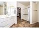 Accessible bathroom with a walk-in shower, grab bars, and vanity with granite countertop at 19824 N 14Th Pl, Phoenix, AZ 85024