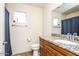 Bathroom featuring a wooden vanity with granite countertop, and a toilet for convenience at 19824 N 14Th Pl, Phoenix, AZ 85024