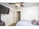 Bright bedroom featuring a bed with a grey blanket, a ceiling fan, and a closet with sliding doors at 19824 N 14Th Pl, Phoenix, AZ 85024