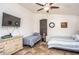 Cozy bedroom featuring two beds, a ceiling fan, and ample natural light from the window at 19824 N 14Th Pl, Phoenix, AZ 85024